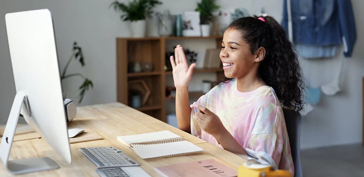 Girl saying hi to the computer camera